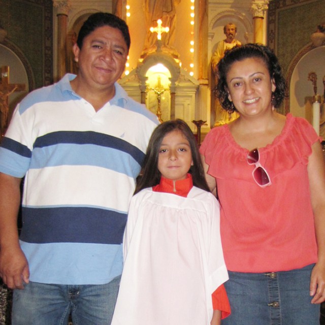 Parents Marco and Veronica with our newest altar server, Karen